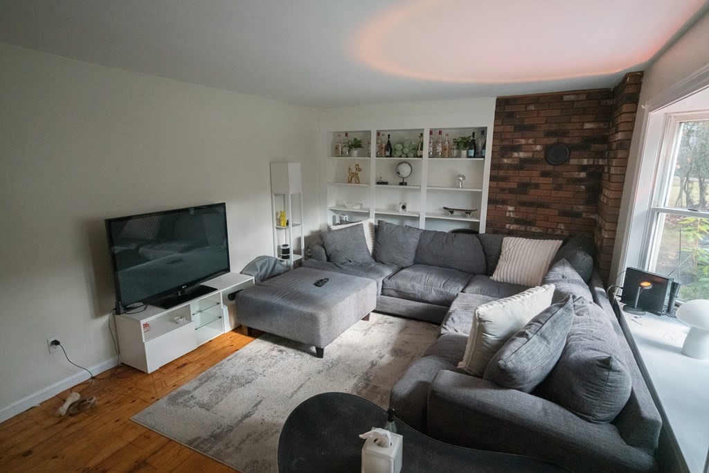 370 Pelham Road Amherst, MA 01002 - Photo 3 of 13 a living room with furniture and a flat screen tv