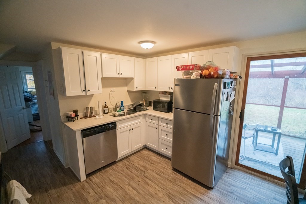 370 Pelham Road Amherst, MA 01002 - Photo 5 of 13 a kitchen with a refrigerator sink and cabinets