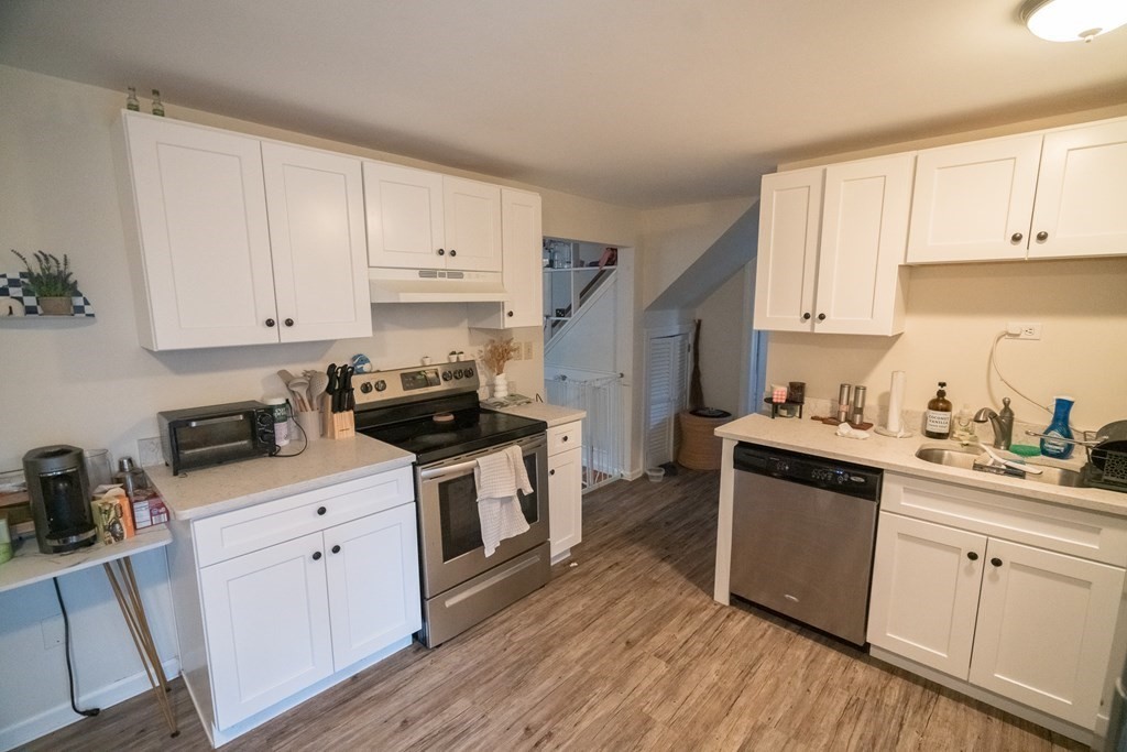 370 Pelham Road Amherst, MA 01002 - Photo 6 of 13 a kitchen with granite countertop white cabinets sink and stainless steel appliances