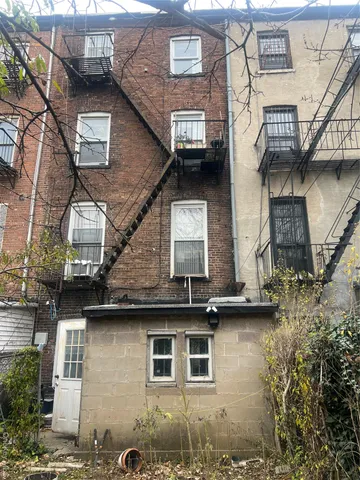 a front view of a house with plants