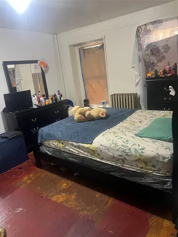 a bedroom with bed and window