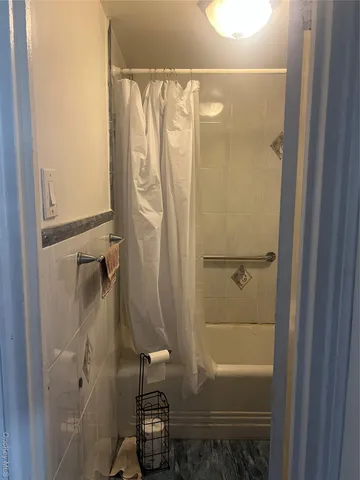 a bathroom with a shower and a tub