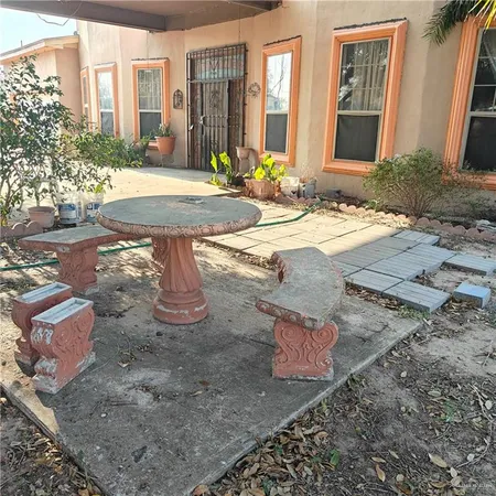 a view of a house with backyard and sitting area