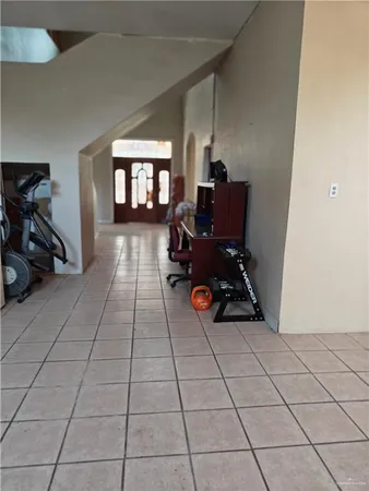 a view of a room with gym equipment and a window