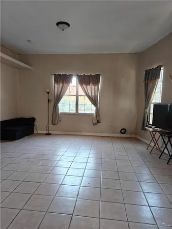 a view of empty room with a fireplace