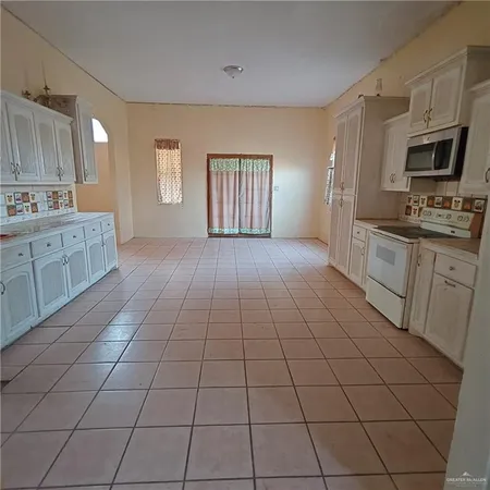 a large kitchen with cabinets and appliances