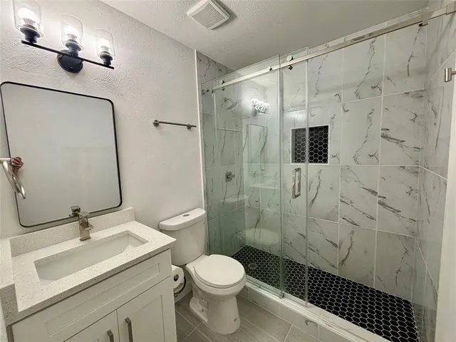 a bathroom with a sink toilet and shower