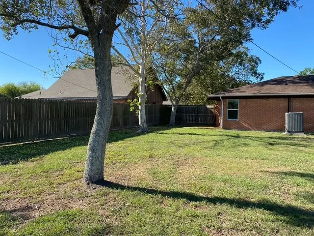 a black car parked in front of a house