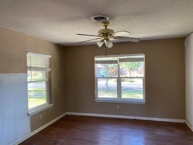 a view of a livingroom with a ceiling fan and window