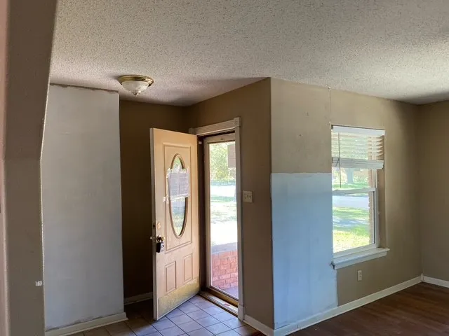 a view of hallway with windows and wooden floor