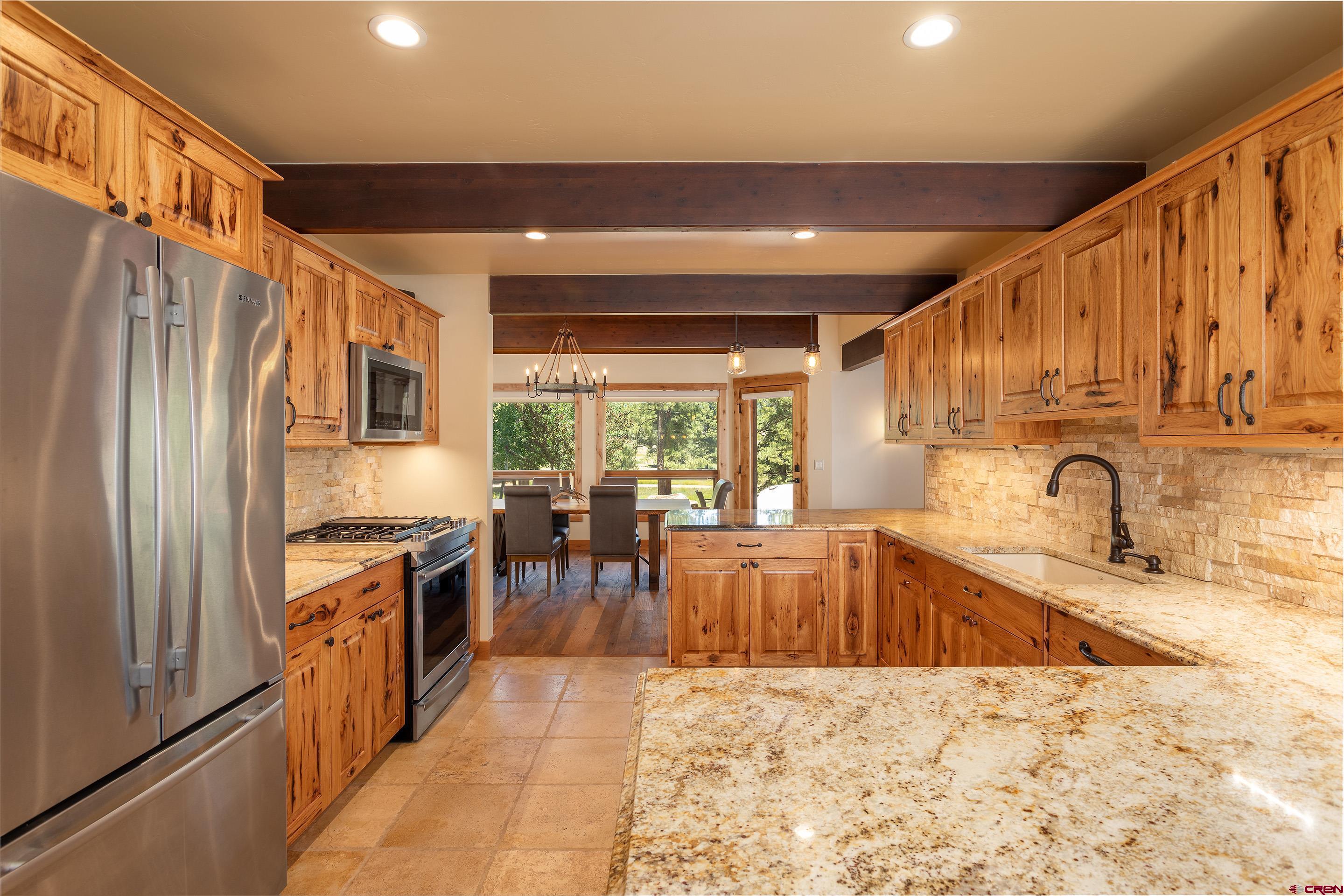 378 Colonial Drive Hesperus, CO 81326 - Photo 11 of 34 a kitchen with stainless steel appliances granite countertop a sink stove and refrigerator