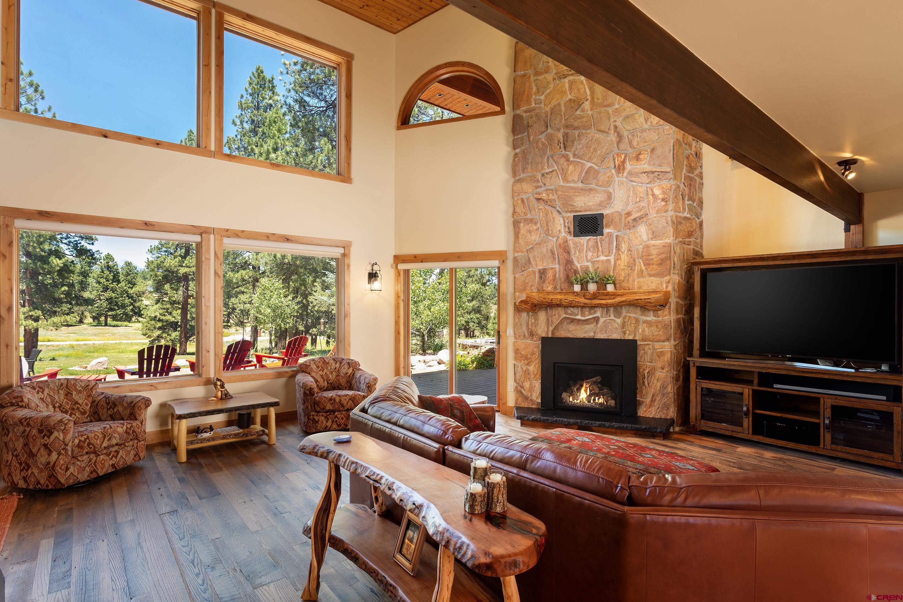 378 Colonial Drive Hesperus, CO 81326 - Photo 15 of 34 a living room with furniture a flat screen tv and a fireplace