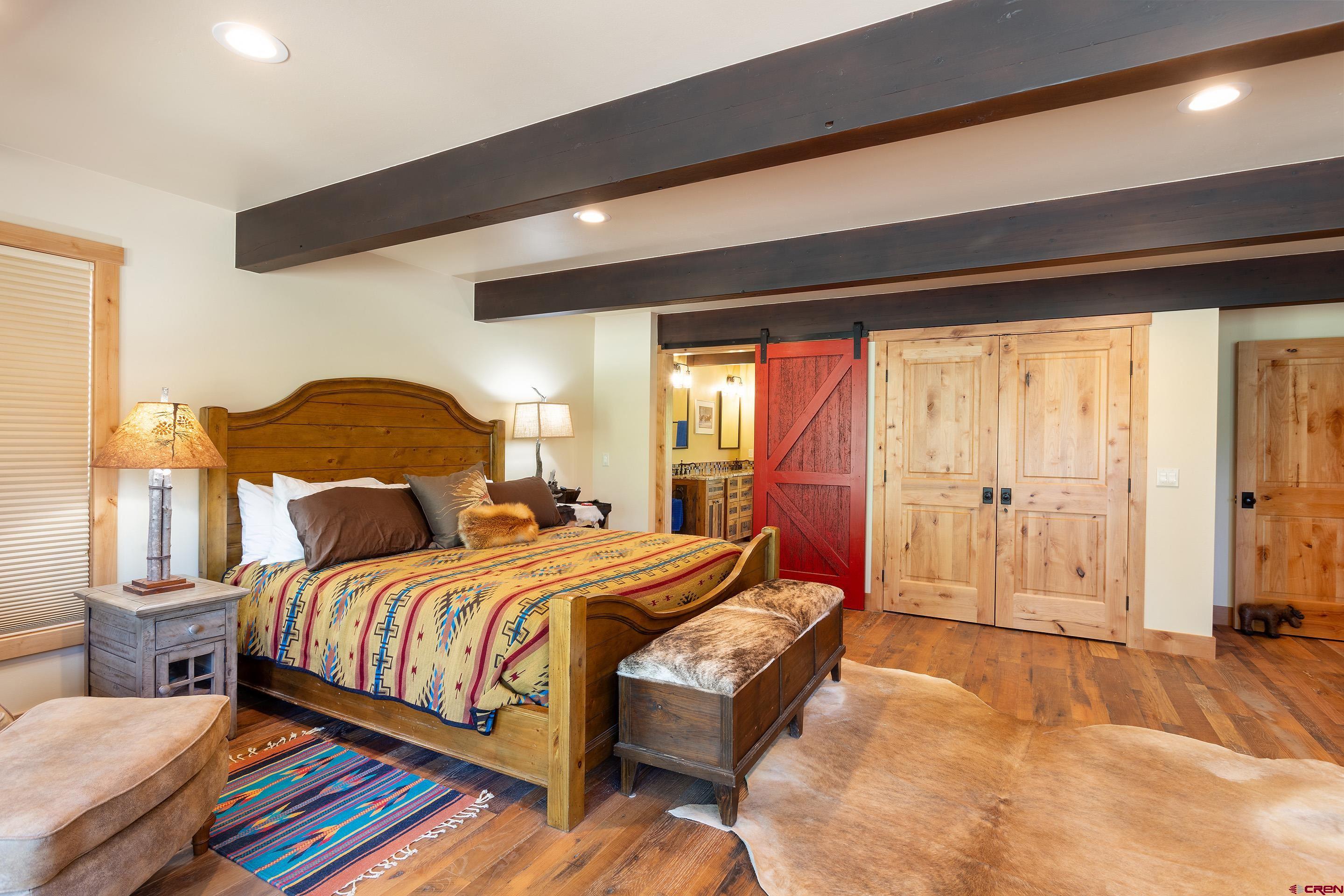 378 Colonial Drive Hesperus, CO 81326 - Photo 19 of 34 a bedroom with a bed and wooden floor