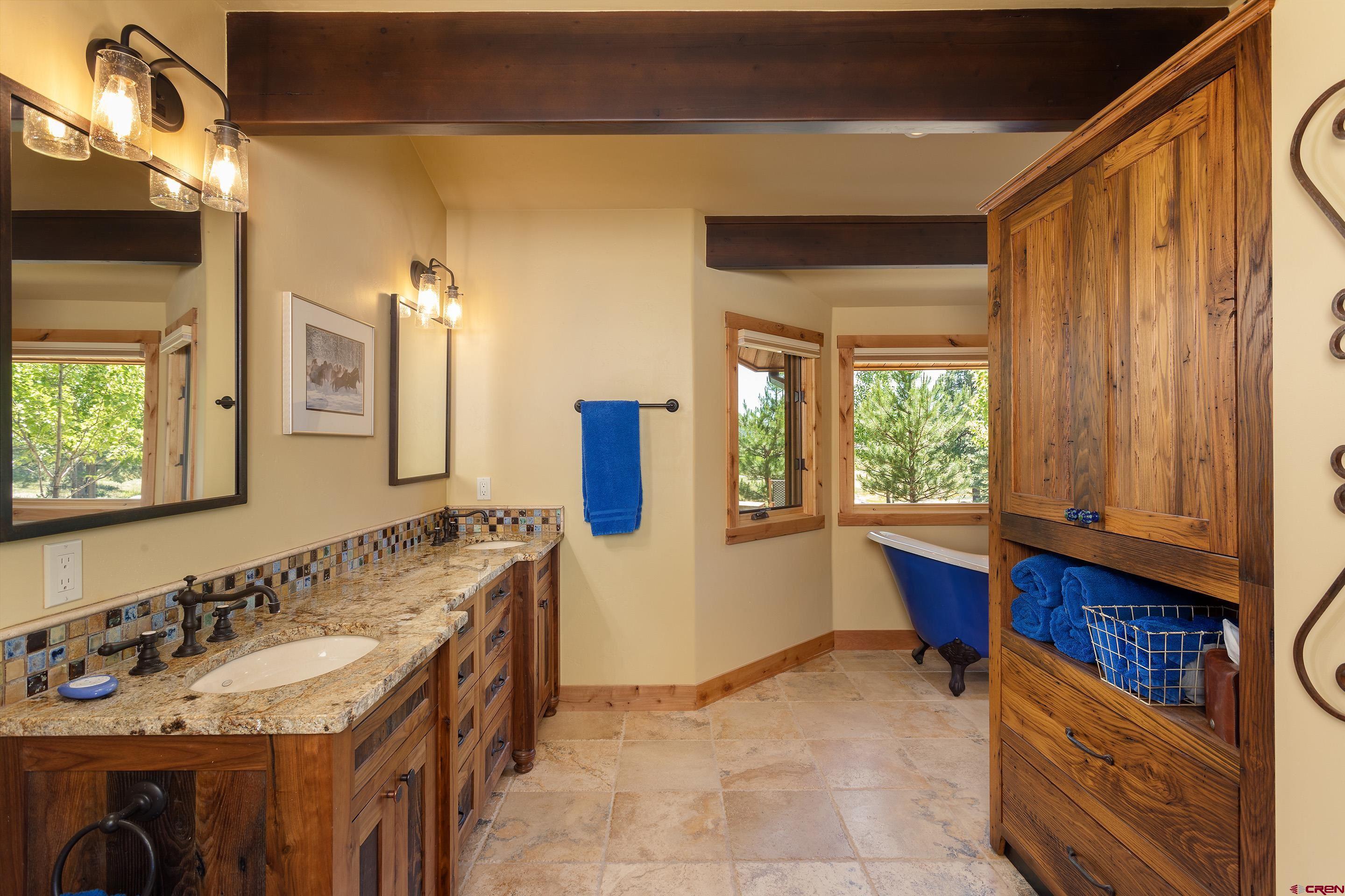 378 Colonial Drive Hesperus, CO 81326 - Photo 21 of 34 a bathroom with a tub sink and mirror