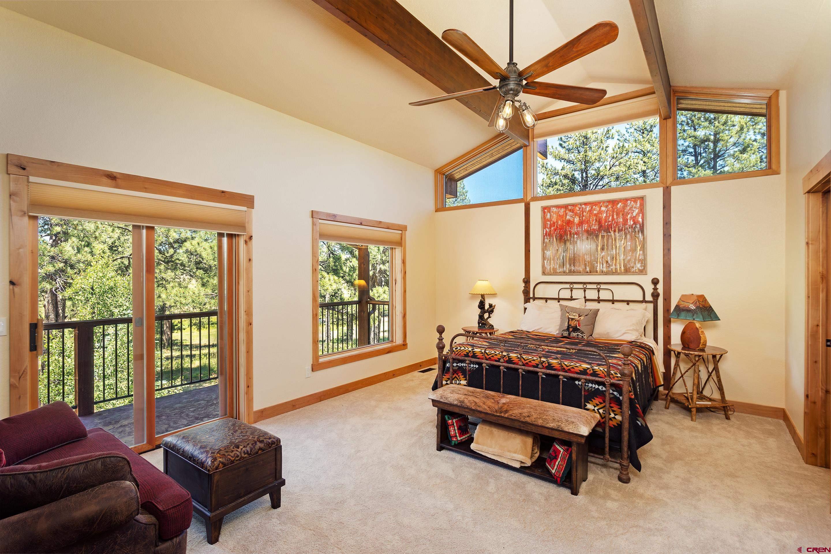 378 Colonial Drive Hesperus, CO 81326 - Photo 24 of 34 a bedroom with a bed and a couch next to a window