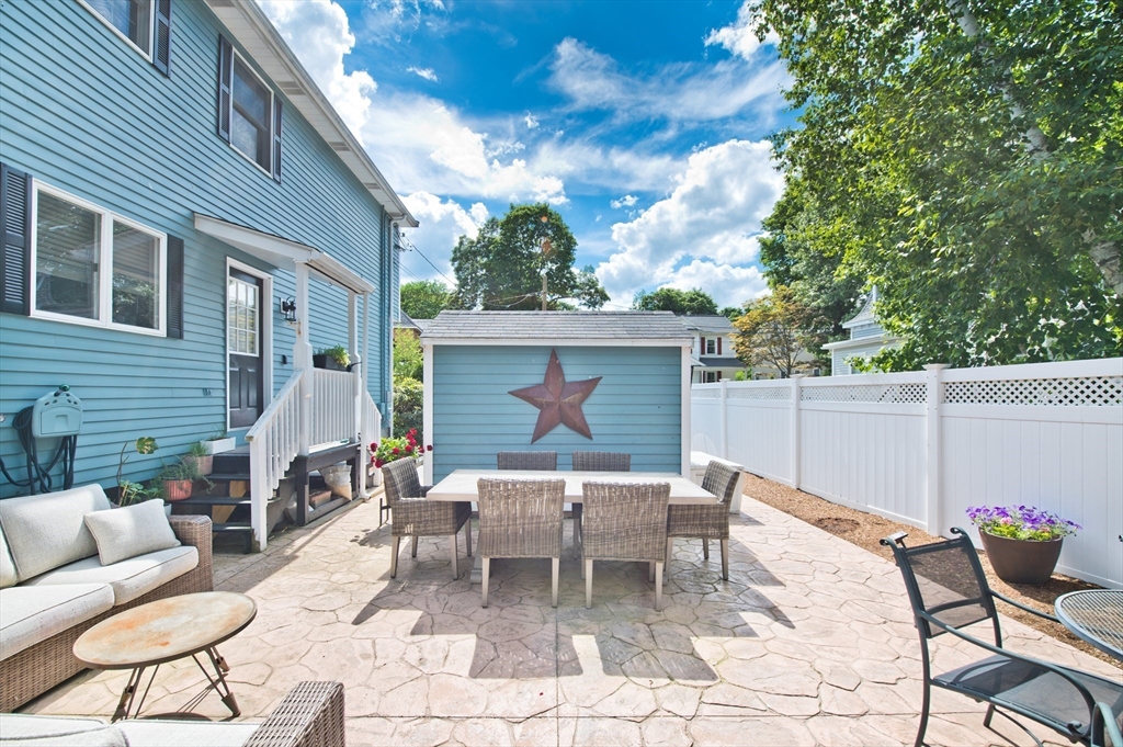 16 Warren Avenue Newton, MA 02465 - Photo 30 of 42 a backyard of a house with table and chairs