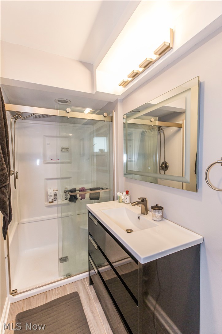 2095 Wyndham Road Akron, OH 44313 - Photo 26 of 40 En Suite Bathroom with vanity, walk in shower, and hardwood / wood-style floors