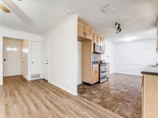 a view of a kitchen with wooden floor and a sink