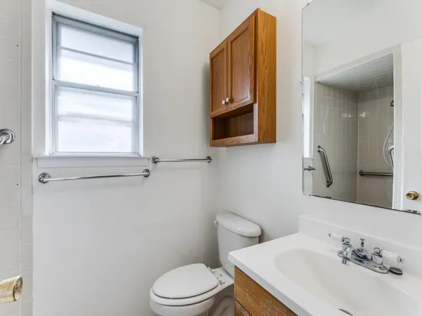 a bathroom with a sink a toilet and mirror