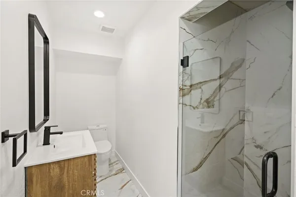 a bathroom with a glass shower door