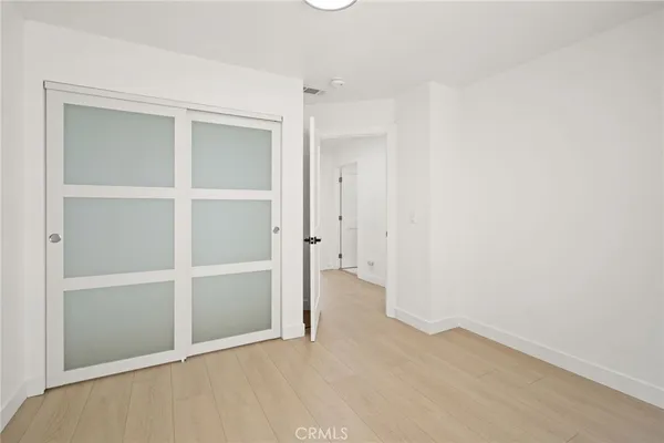 a view of a room with wooden floor