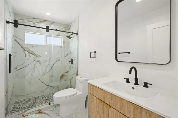 a bathroom with a sink a mirror and shower