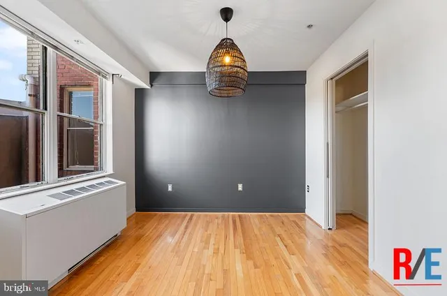 a view of empty room with wooden floor