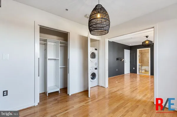 a view of entryway and hall with wooden floor