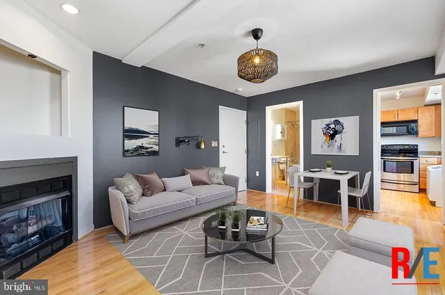 a living room with furniture and a fireplace