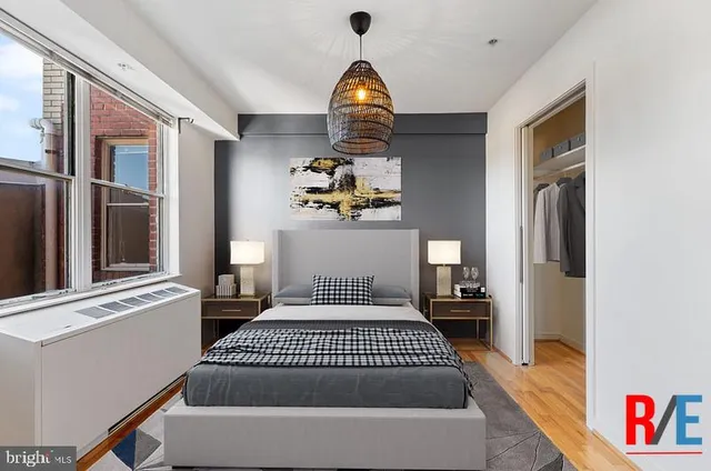 a bedroom with a bed and a window