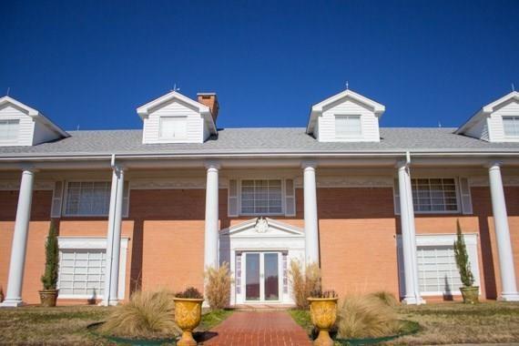 a view of a white building with large windows