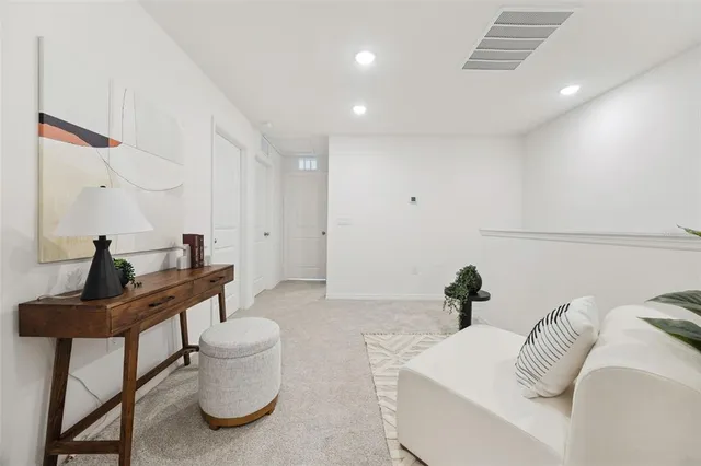 a living room with furniture and a potted plant