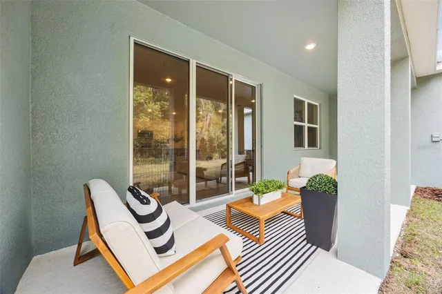 a view of a balcony with floor to ceiling windows with wooden floor