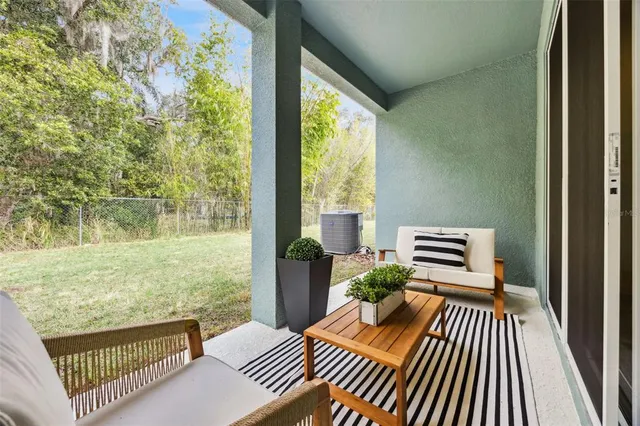 a outdoor view of a house with a lounge chair