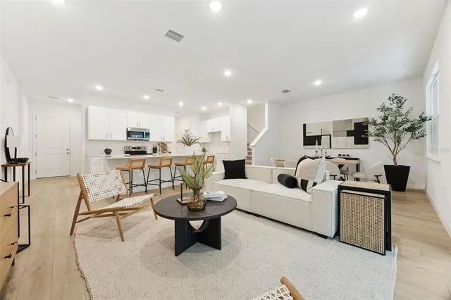a living room with furniture and kitchen view