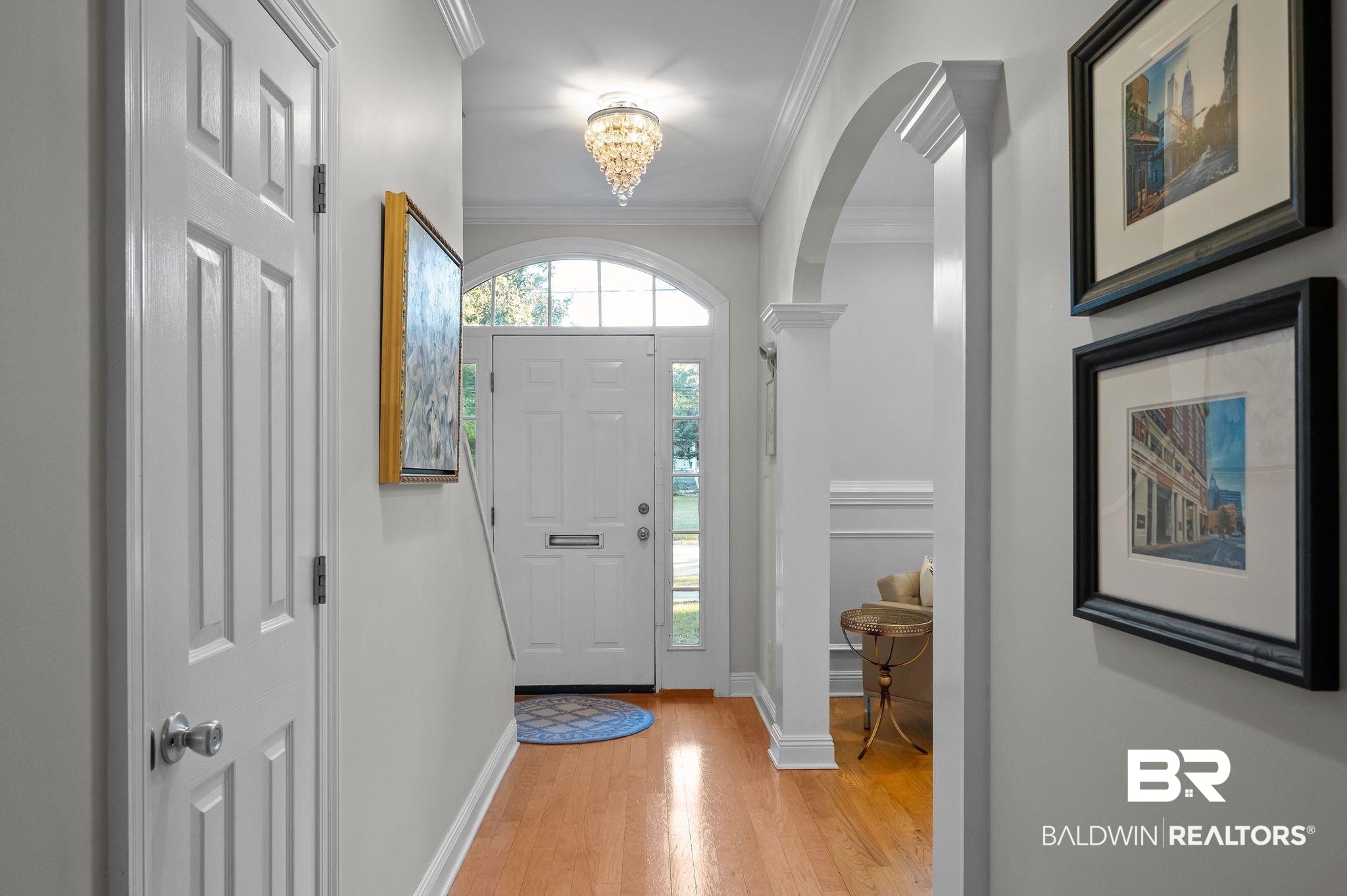 1825 Spring Hill Avenue Mobile, AL 36607 - Photo 5 of 43 Entryway featuring a chandelier, ornamental molding, light wood-type flooring, and arched walkways