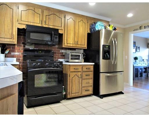 95 Powers Road Holden, MA 01520 - Photo 12 of 29 a kitchen with stainless steel appliances a stove a microwave and a refrigerator