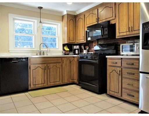 95 Powers Road Holden, MA 01520 - Photo 13 of 29 a kitchen with stainless steel appliances granite countertop a stove a sink and a microwave