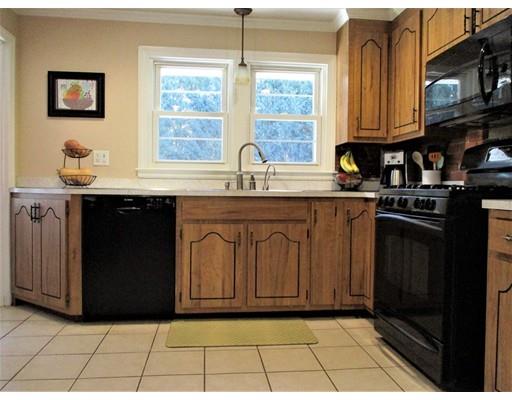 95 Powers Road Holden, MA 01520 - Photo 10 of 29 a kitchen with stainless steel appliances granite countertop a stove a sink and a microwave