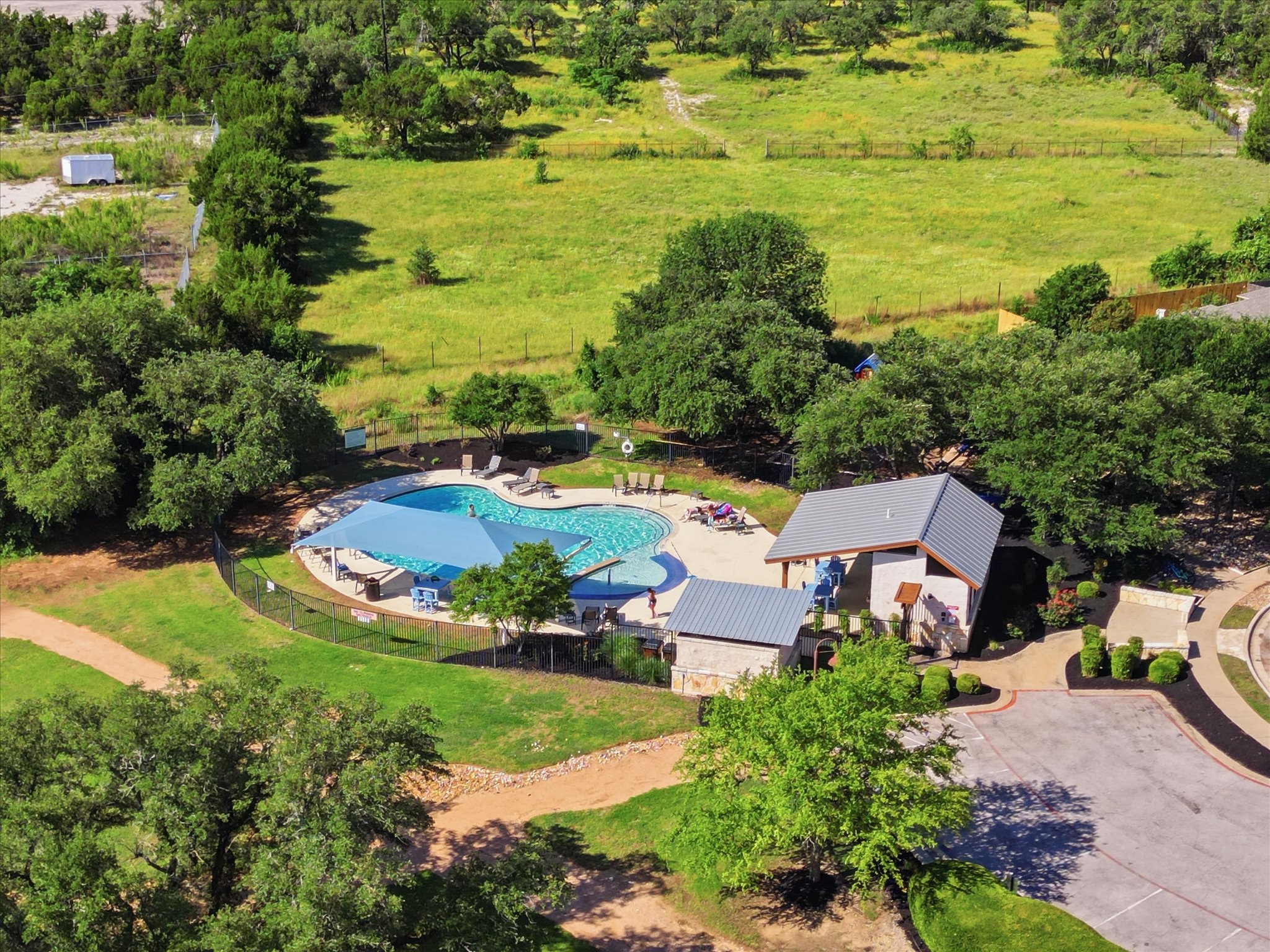 1511 Rimstone Drive Cedar Park, TX 78613 - Photo 35 of 39 An aerial perspective reveals a serene community pool area, offering an ideal space for recreation and relaxation.