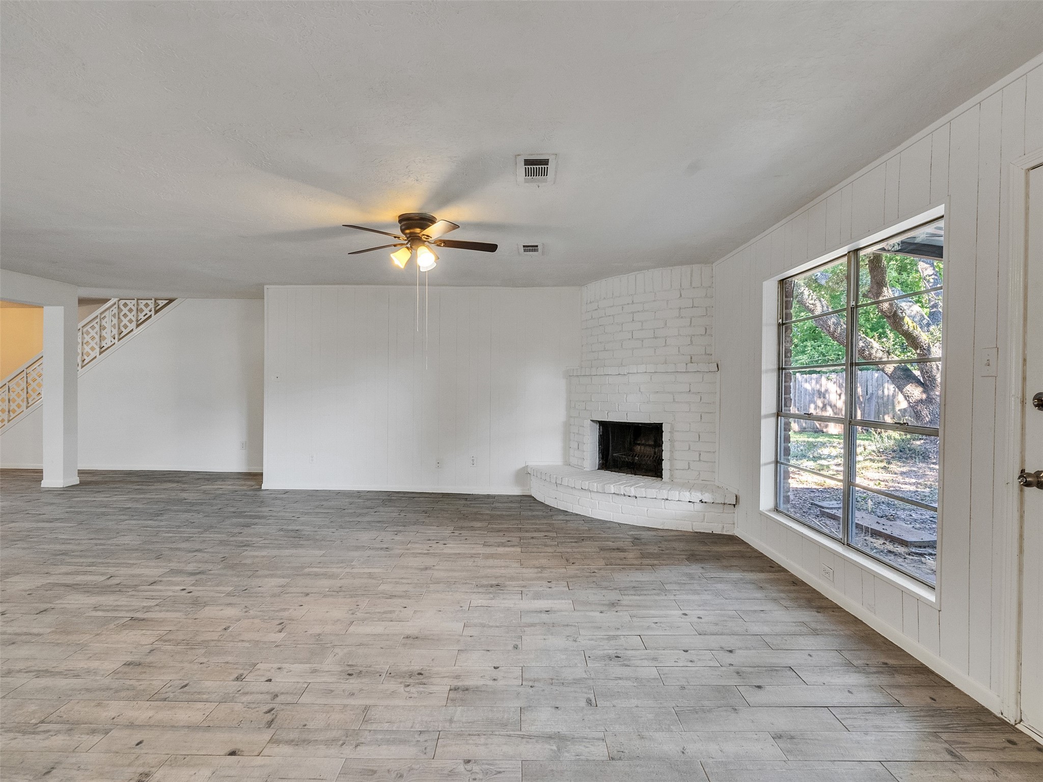 12710 Crow Valley Lane Houston, TX 77099 - Photo 14 of 34 a view of an empty room with a fireplace and a window