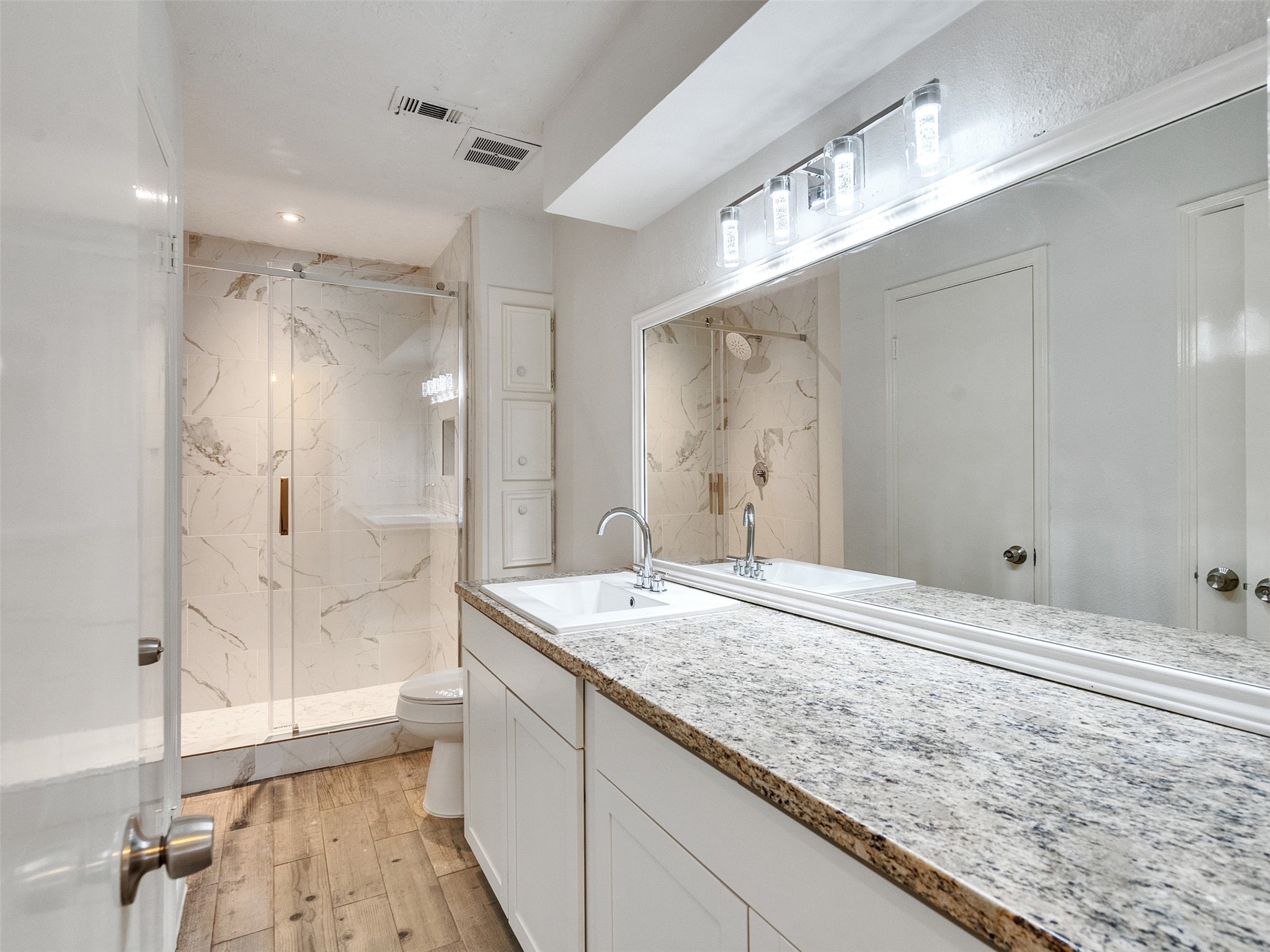 12710 Crow Valley Lane Houston, TX 77099 - Photo 17 of 34 a bathroom with a granite countertop sink mirror and shower