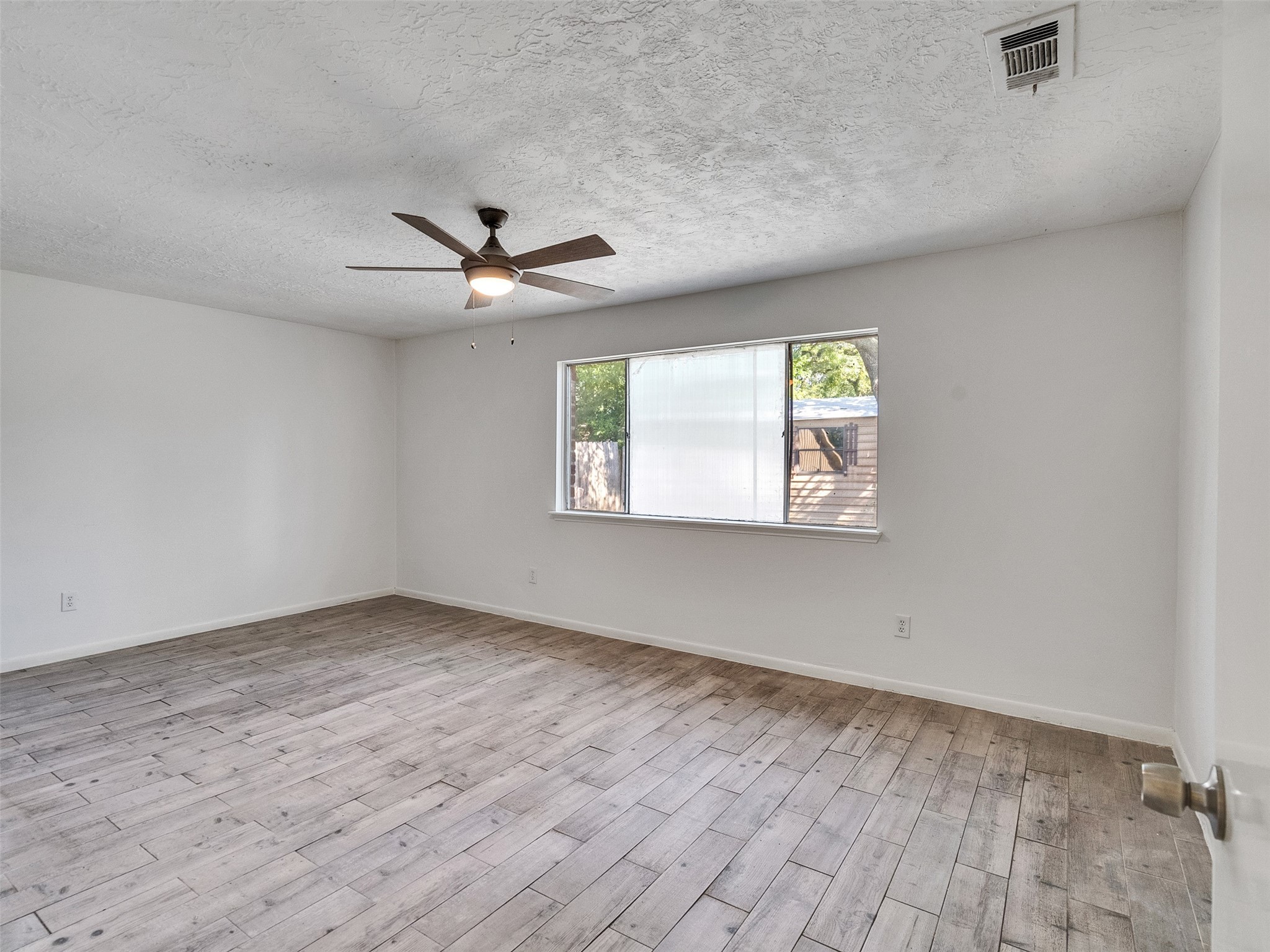 12710 Crow Valley Lane Houston, TX 77099 - Photo 18 of 34 wooden floor in an empty room with a window