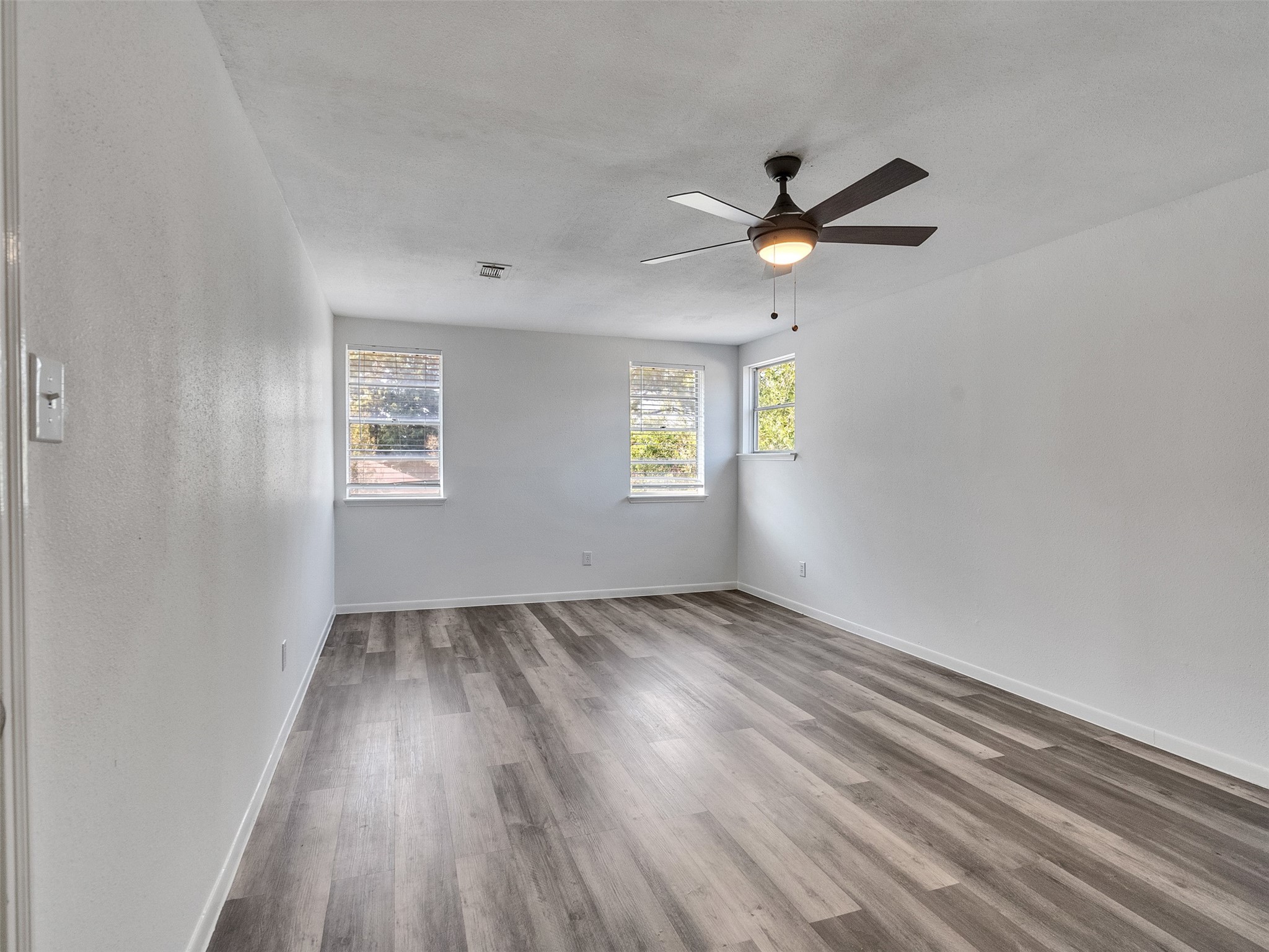 12710 Crow Valley Lane Houston, TX 77099 - Photo 20 of 34 wooden floor in an empty room with a window