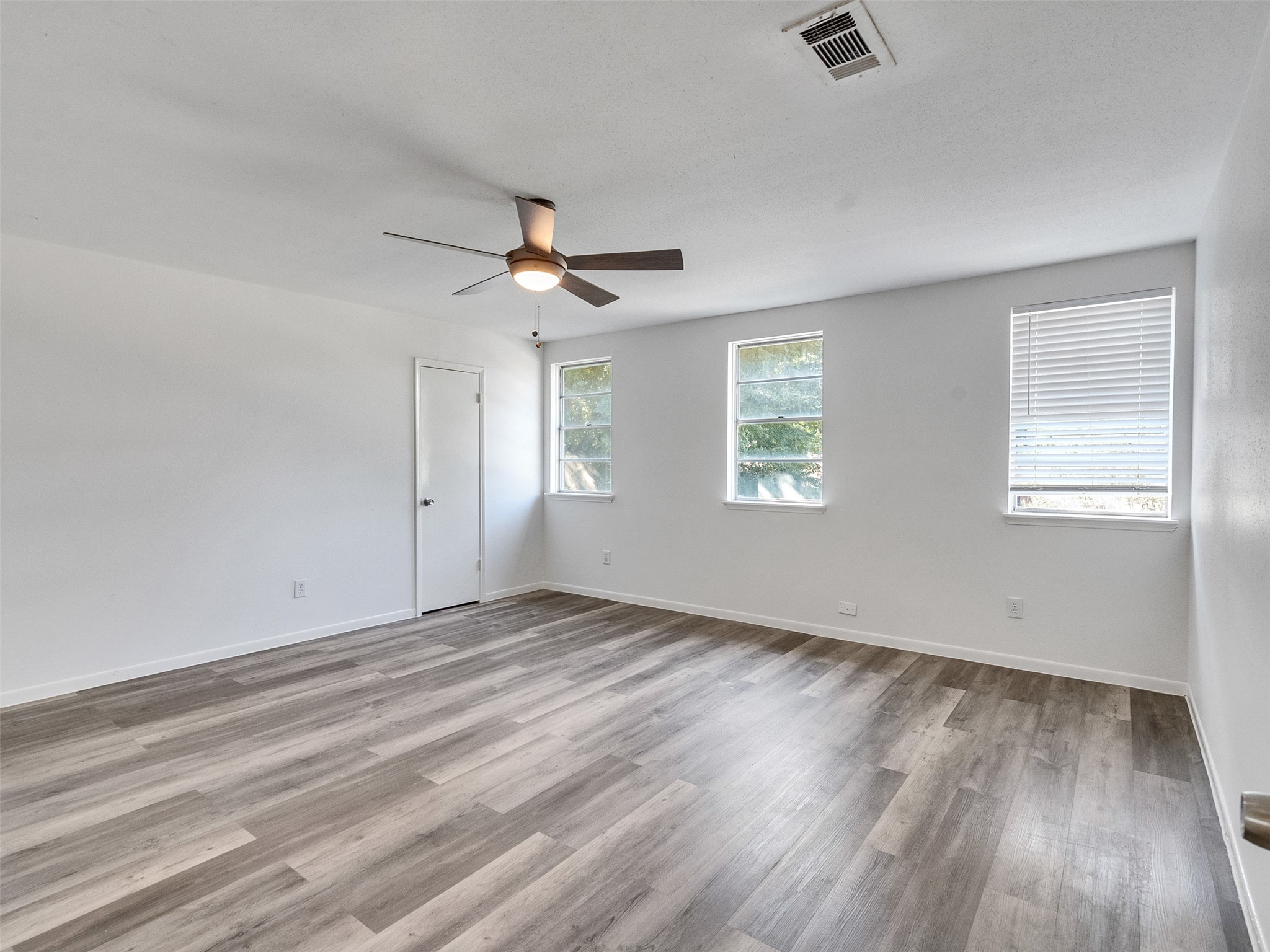 12710 Crow Valley Lane Houston, TX 77099 - Photo 22 of 34 a view of an empty room with a window and wooden floor