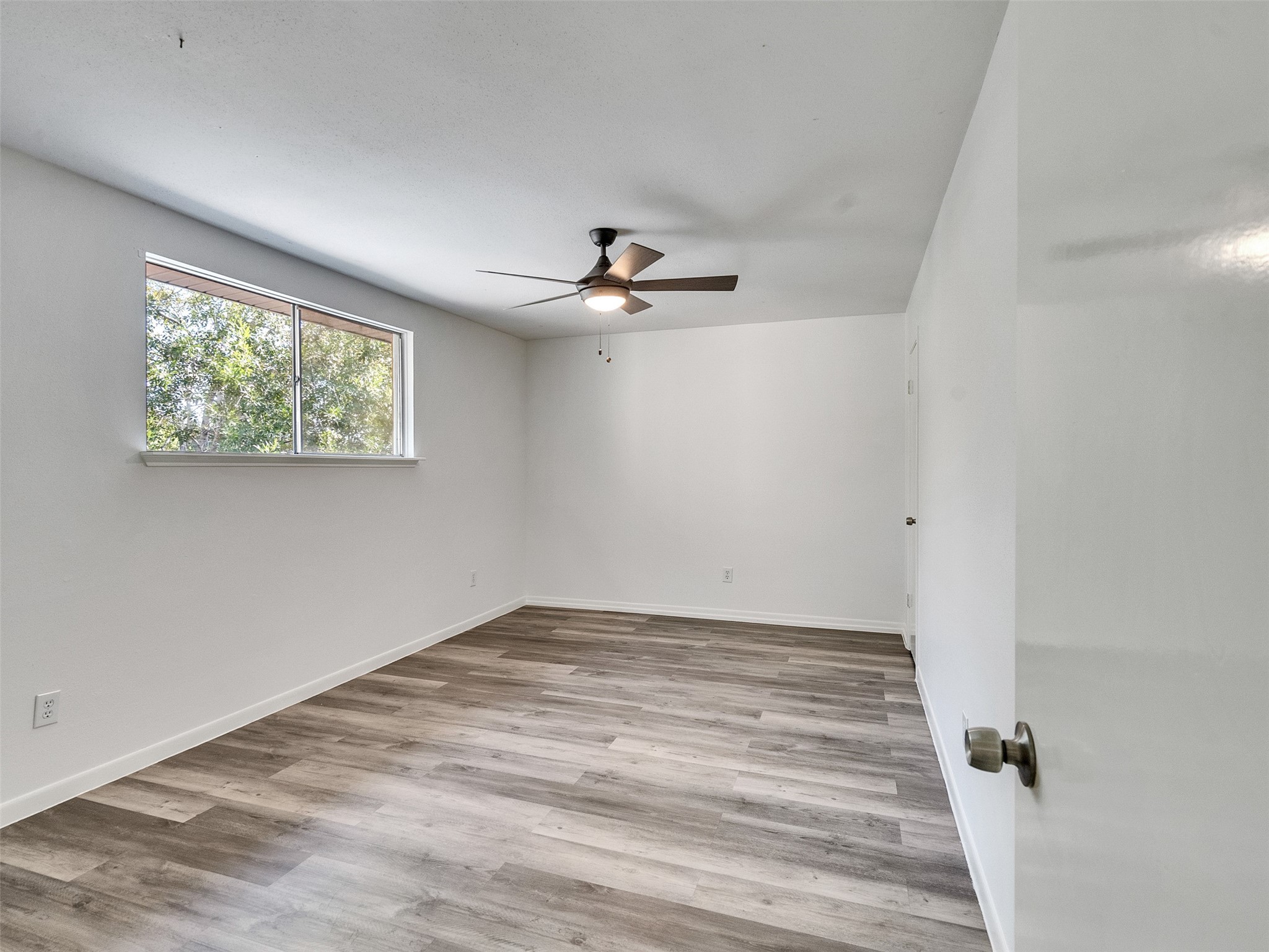 12710 Crow Valley Lane Houston, TX 77099 - Photo 23 of 34 wooden floor in an empty room with a window