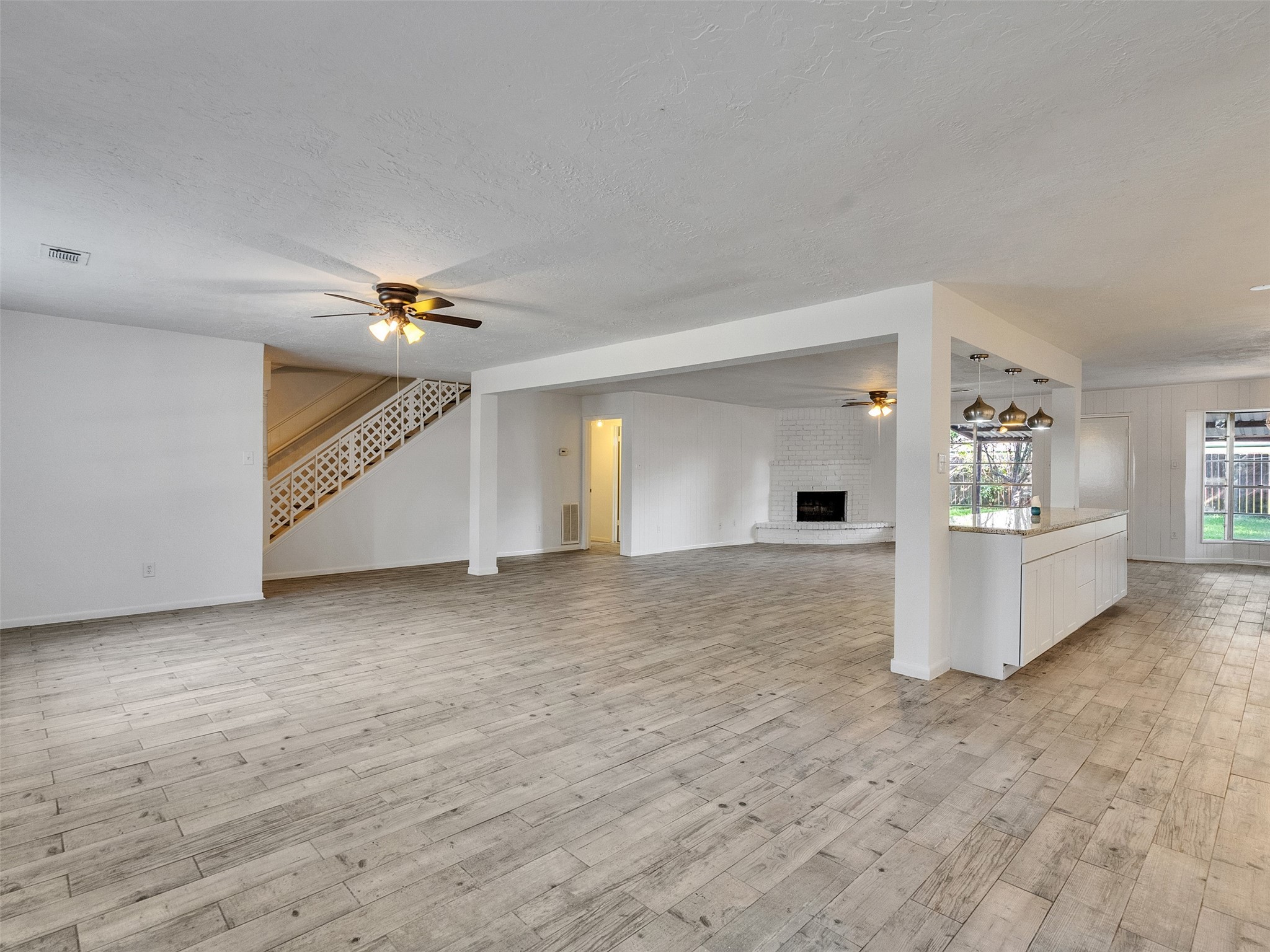 12710 Crow Valley Lane Houston, TX 77099 - Photo 7 of 34 a view of a livingroom with a kitchen and fireplace