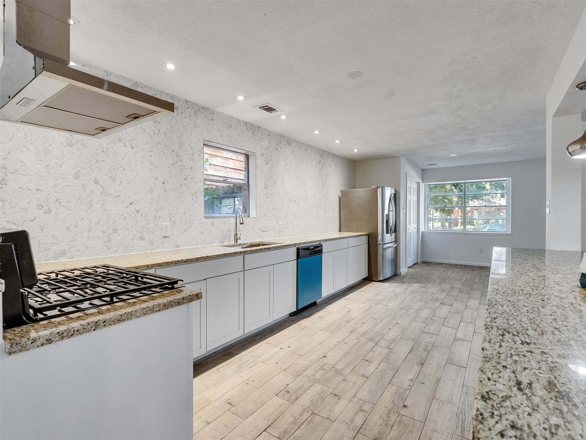 12710 Crow Valley Lane Houston, TX 77099 - Photo 10 of 34 a kitchen with stainless steel appliances granite countertop a stove and a refrigerator