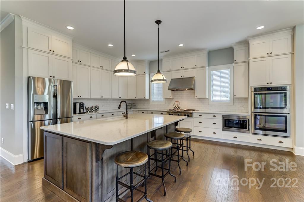 5266 Meadowcroft Way Fort Mill, SC 29708 - Photo 21 of 47 a large kitchen with stainless steel appliances kitchen island a large island in the center