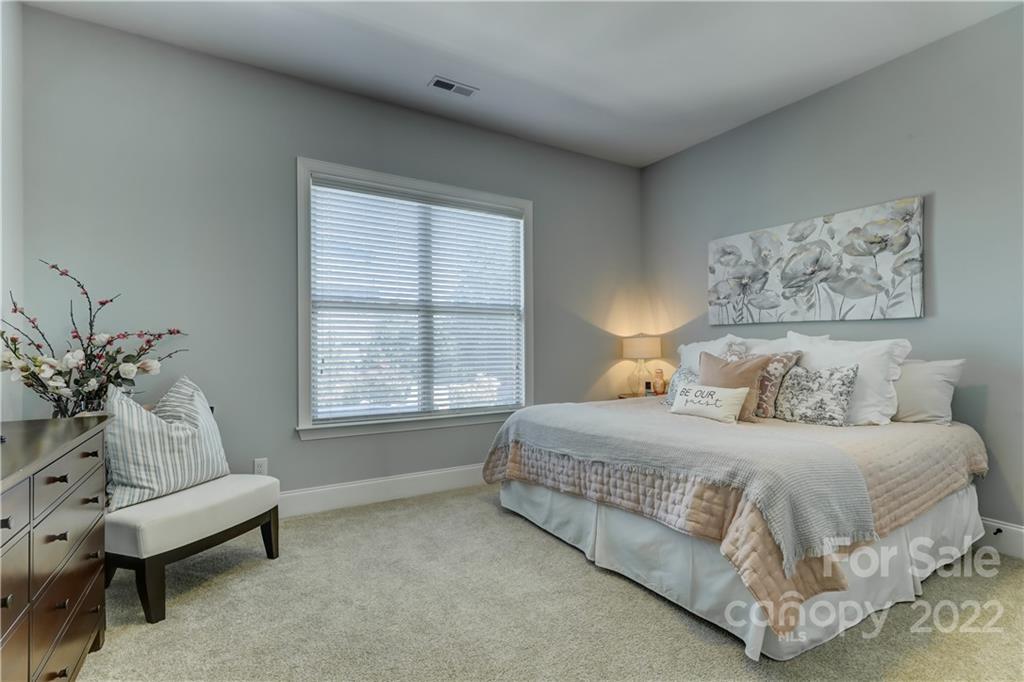 5266 Meadowcroft Way Fort Mill, SC 29708 - Photo 26 of 47 a bedroom with a bed and a couch